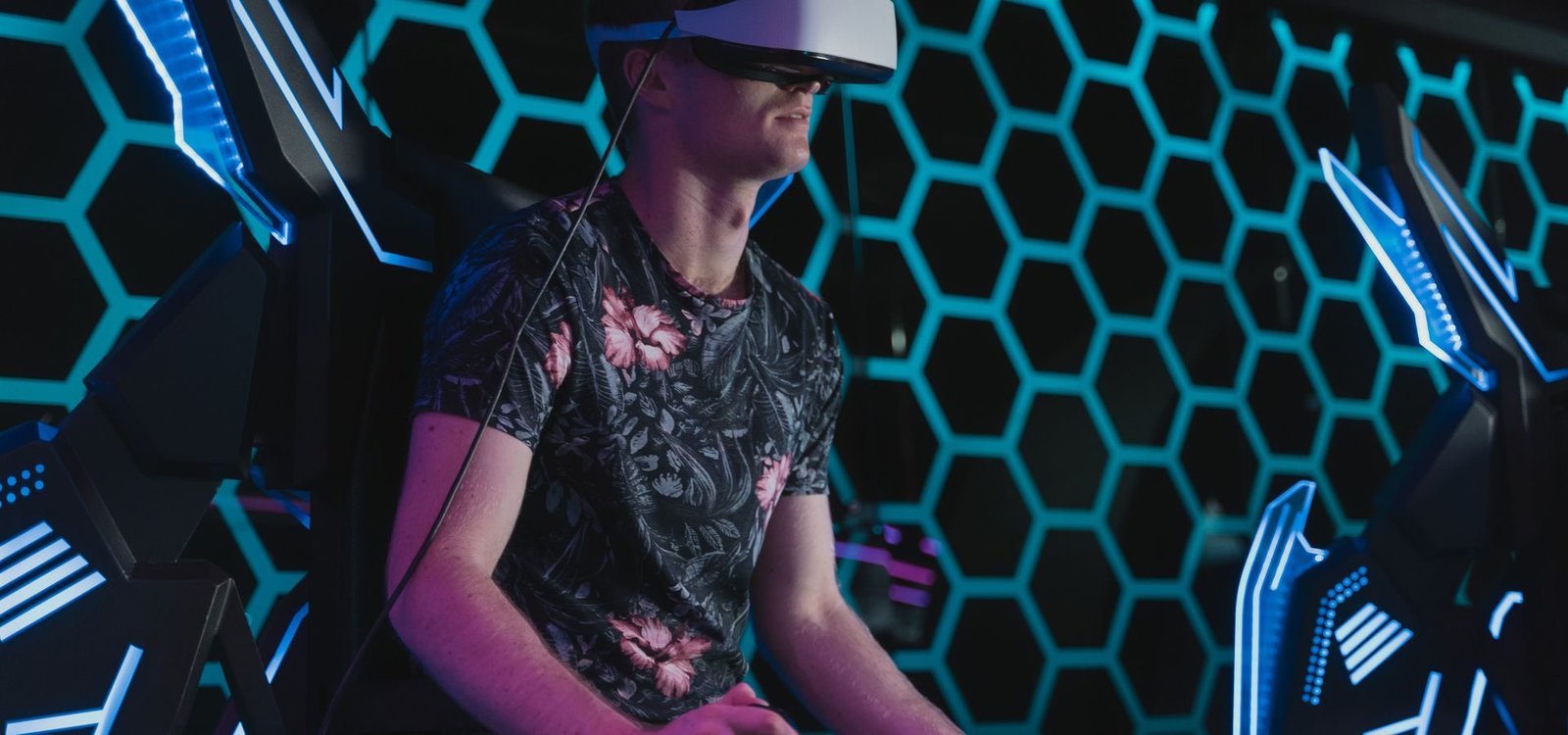 A player mid-session in a neon-lit VR arcade