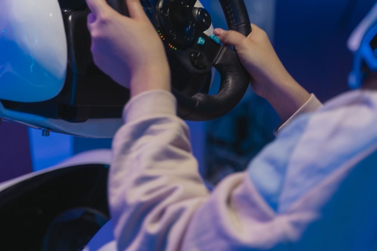 A player's hands on a force-feedback wheel