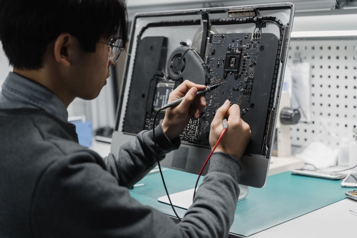 An engineer diagnosing a control board at the bench